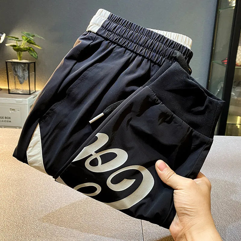 Black ultra-thin ice silk ankle banded cropped trousers for men displayed flat