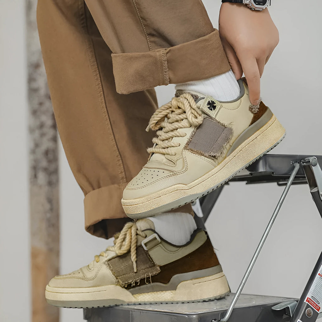 Beige low-top skateboard shoes with microfiber upper and rubber soles on white background