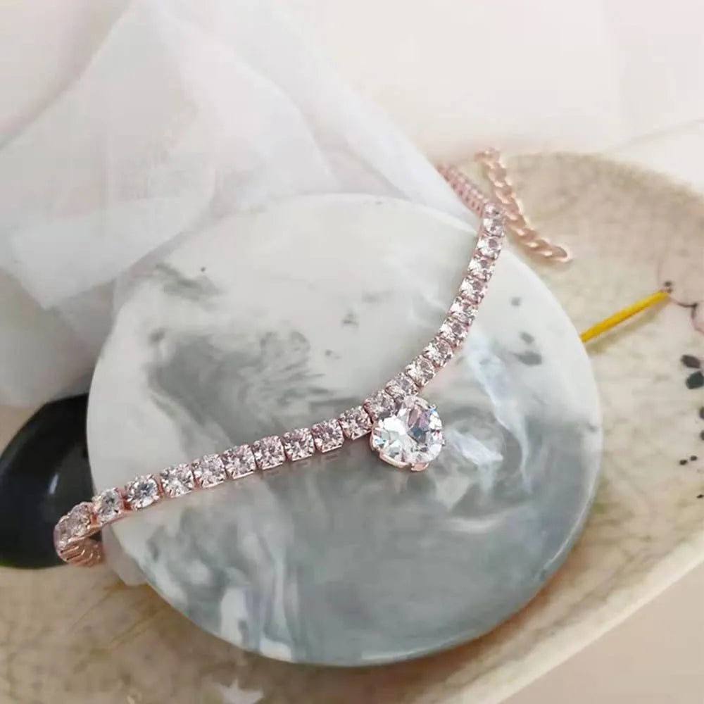 Gold rhinestone heart-shaped collar for a dog or cat on a white background.