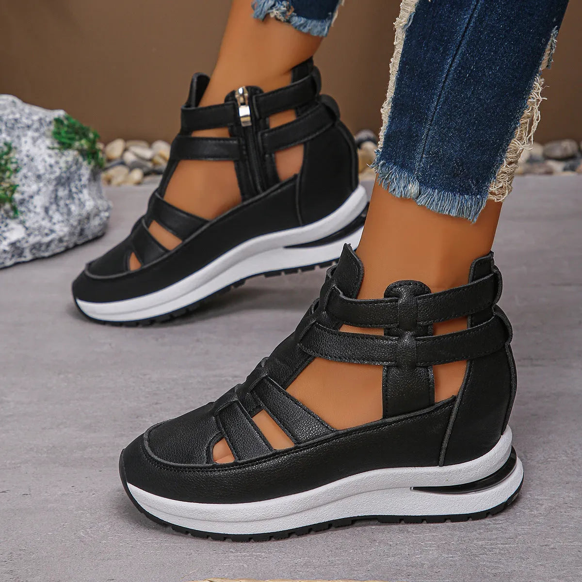 Women's black close-toed hollow-out platform sandals with Velcro strap on a white background.