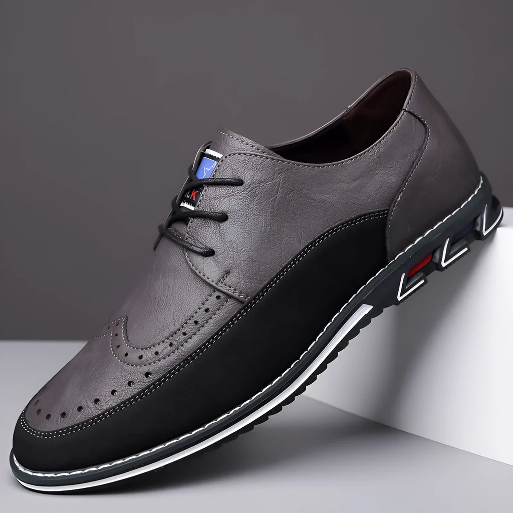 Men's black casual slip-on shoe with leather toe cap and decorative stitching on fabric upper.