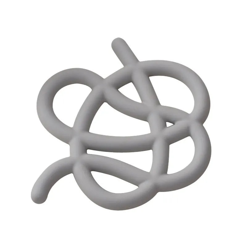 Irregular shaped solid colour ceramic heat proof placemat on a wooden table