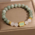 Oil green emerald crystal bracelet for women with five engraved beads.