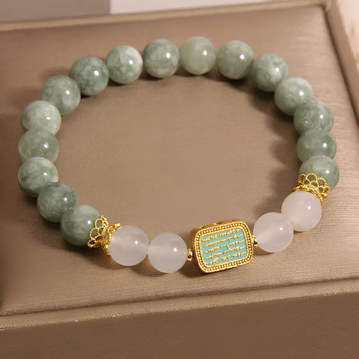 Oil green emerald crystal bracelet for women with five engraved beads.