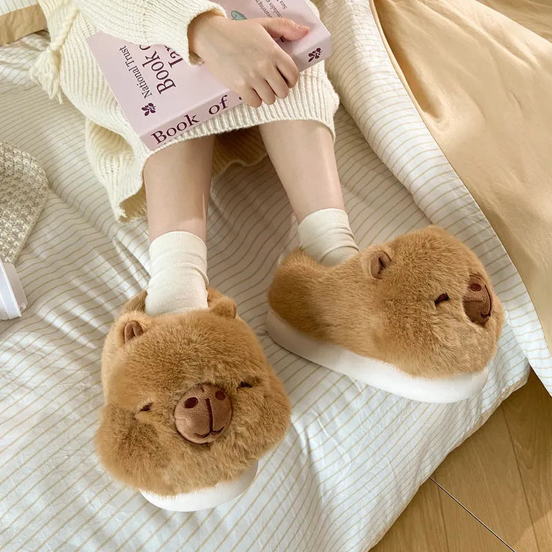 Light brown women's winter plush slippers with a cartoon pattern and artificial wool lining.