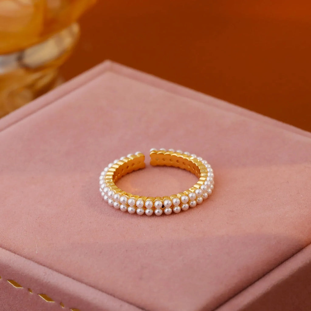 Gold geometric open mouth women's ring with central pearl on copper with electroplated finish