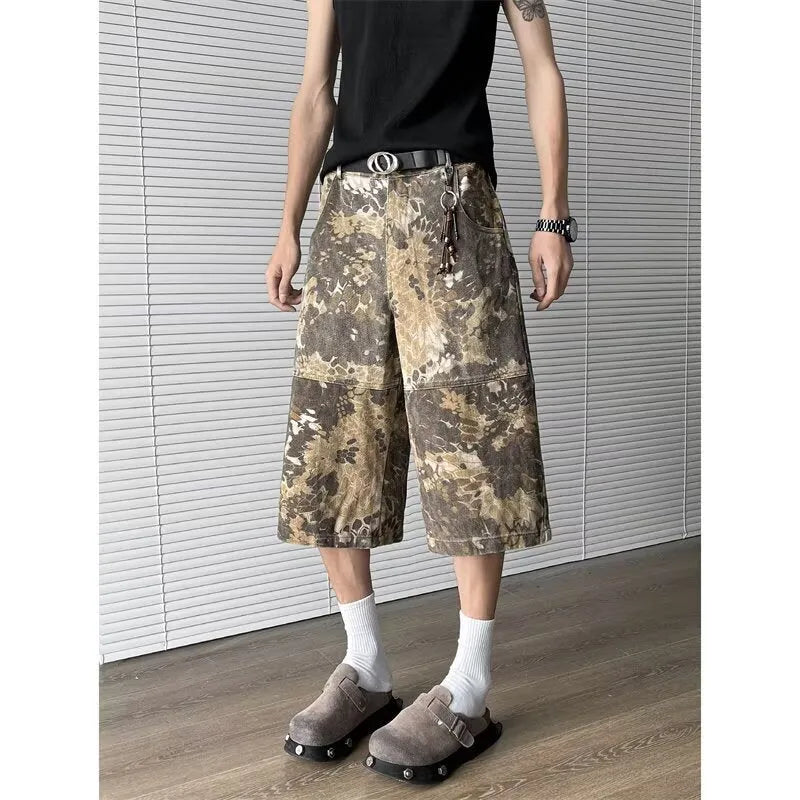 Women's yellow snake pattern camouflage print cropped denim jeans laid flat.