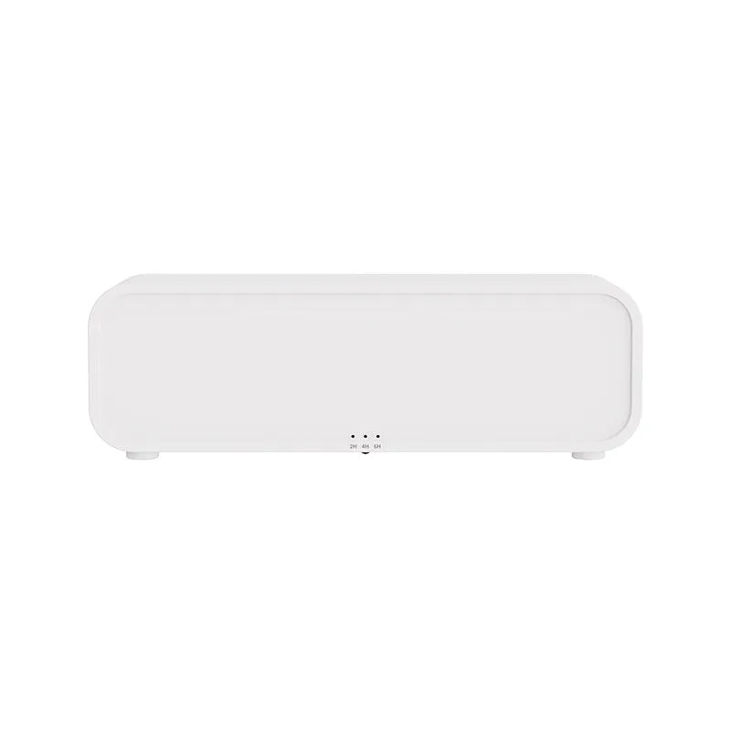 Black aromatherapy diffuser with colour-changing lights and remote control on table
