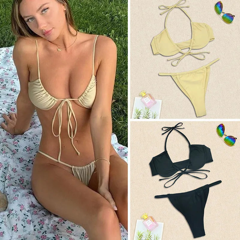 Women's black and mint green split design bikini swimsuit set on a white background.
