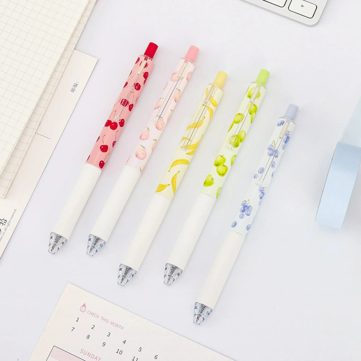 Three fruit-scented press-action pens with plastic barrels and black 0.5mm refills.