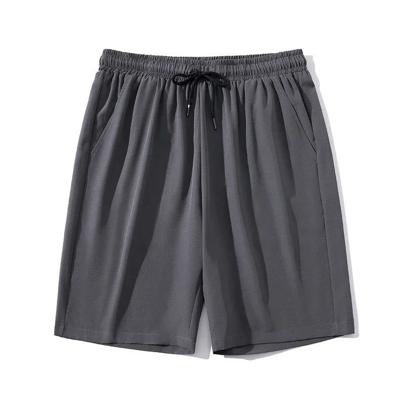 Man wearing gray ice silk nylon cropped sports casual pants with a straight leg.