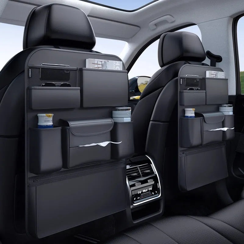 Black leather car seat back storage hanging bag with handle shown on vehicle headrest