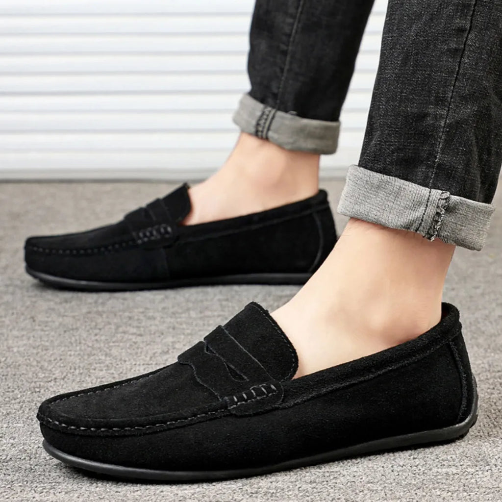 Men's solid colour suede slip-on loafers with a round toe and flat rubber sole.