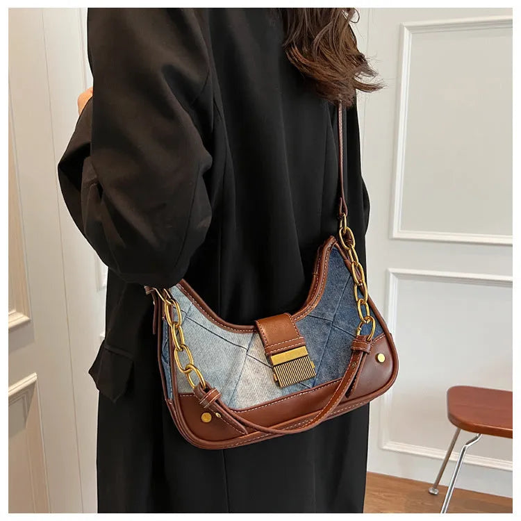 Brown denim women's bucket shoulder bag with chain strap and diamond mesh detail.
