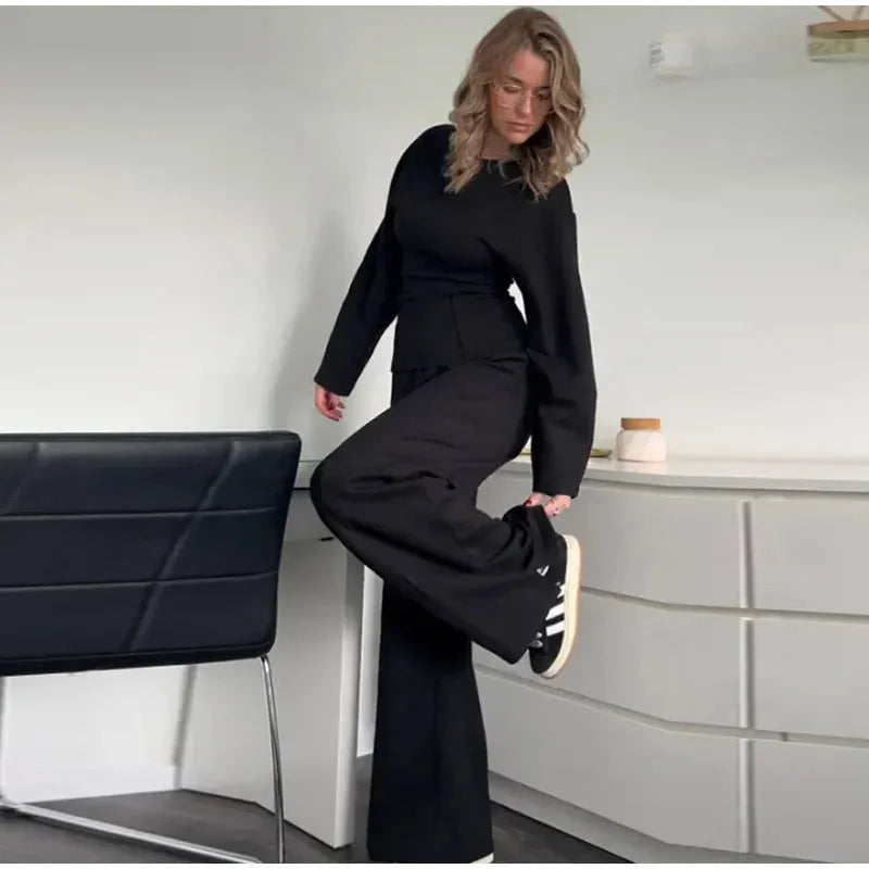 Women's black polar fleece long sleeve pleated top and wide leg trousers suit set.