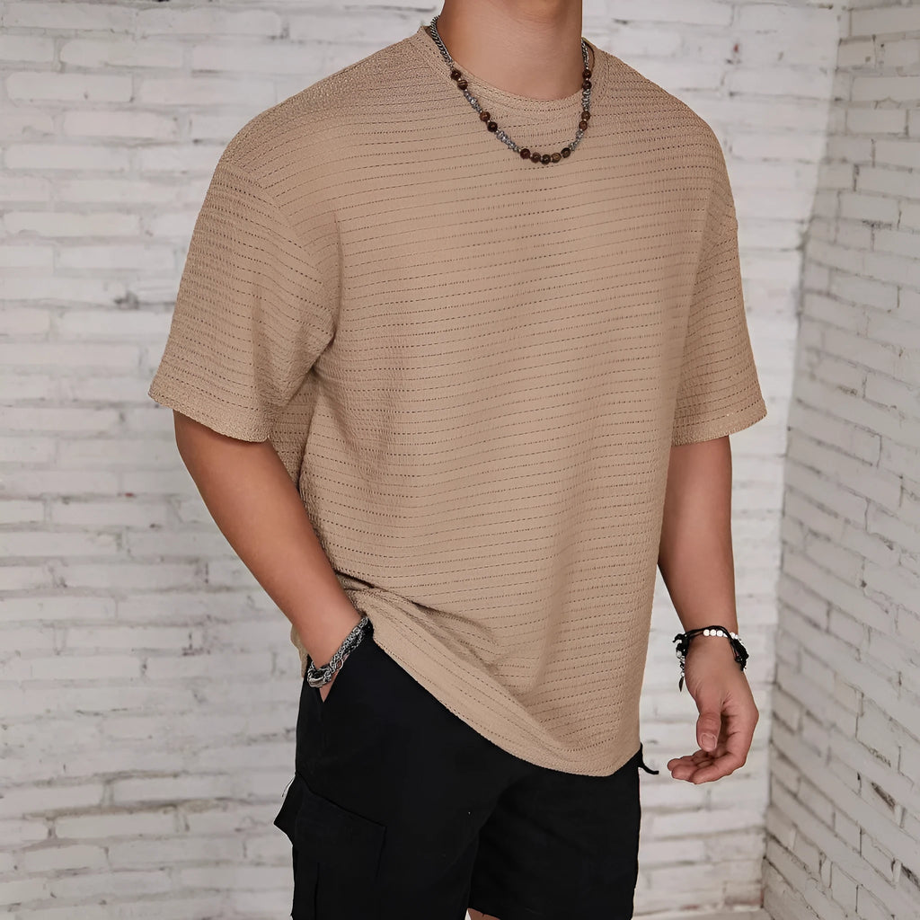 Men's loose fit solid colour round neck t-shirt in polyester on a neutral background.