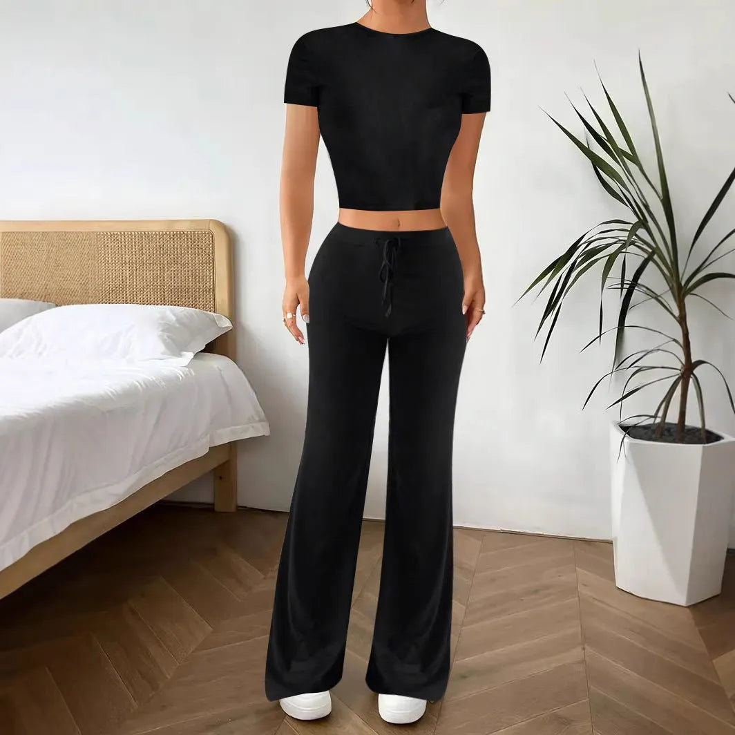Black women's high waist trousers and short sleeve top coordinated suit set on a hanger.