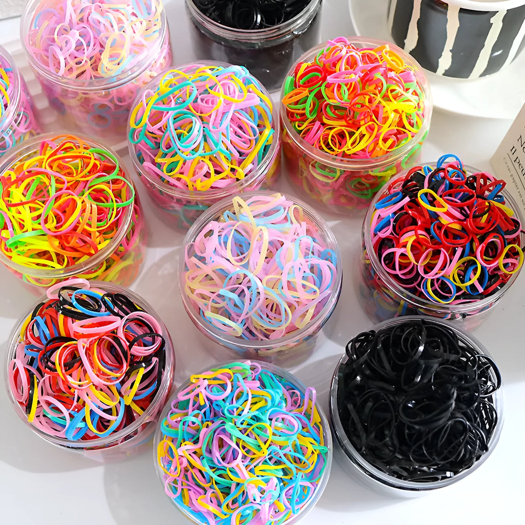 Pack of small, colourful TPU elastic hair bands for babies and toddlers in a reusable container.