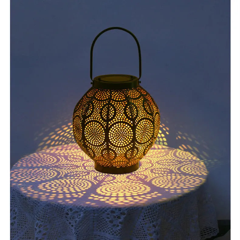 Solar-powered courtyard lamp with hollow iron decorative design showing warm white LED illumination
