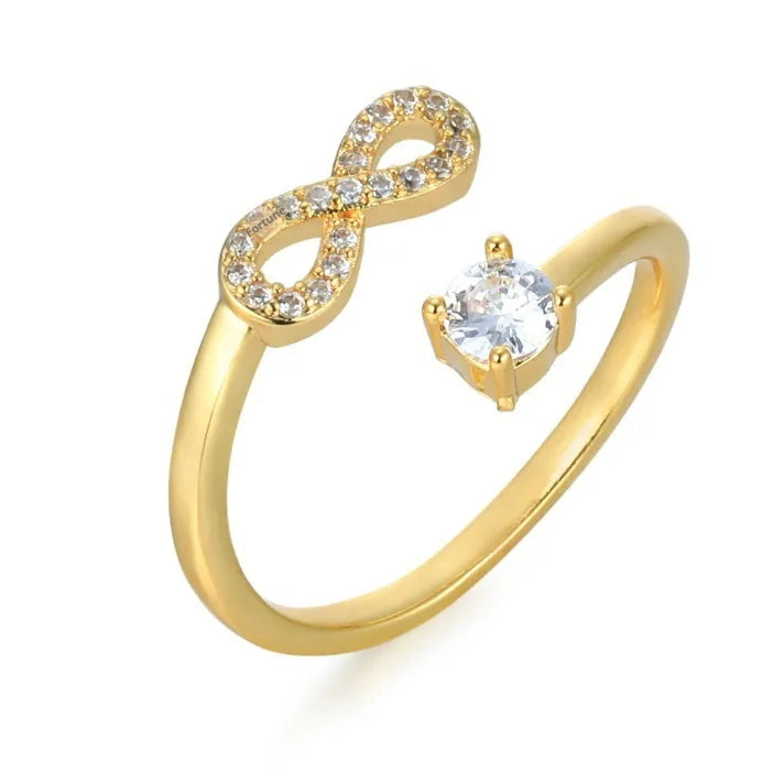 Geometric open band ring with a letter charm and inlaid zircon detail in gold colour.