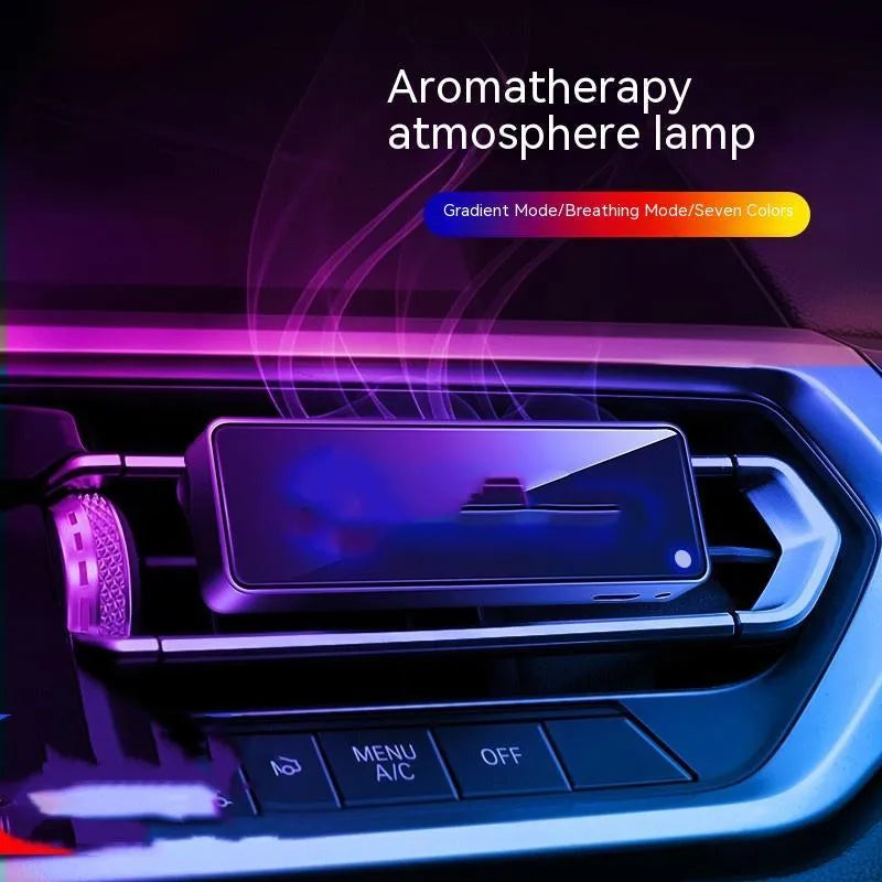 Black automobile aromatherapy air outlet ambience light with LED illumination on car dashboard