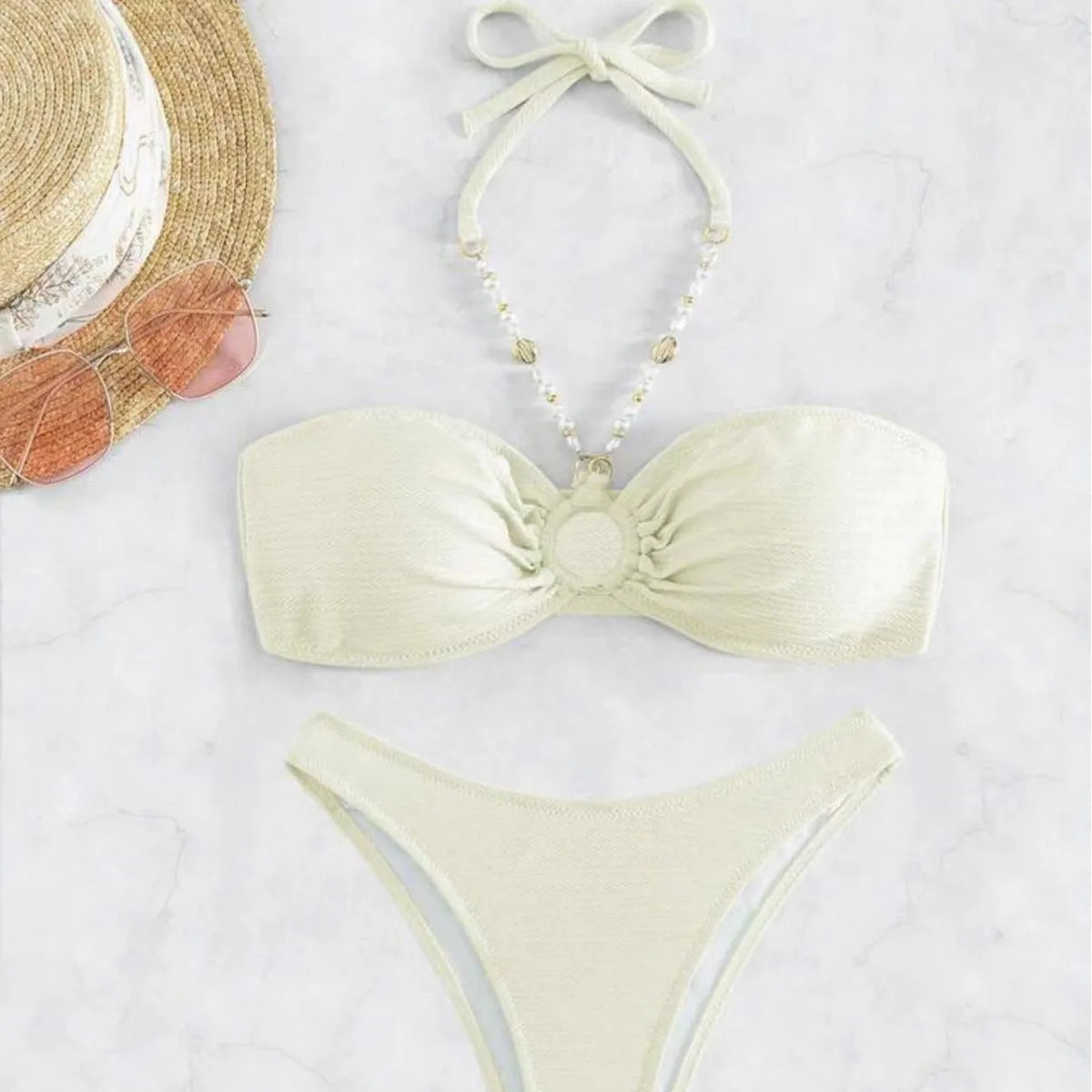 Women's pure colour halter neck bikini set on a hanger, shown in creamy-white.