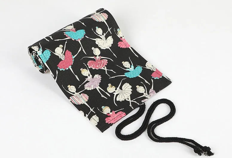 Square canvas rolling pencil case with ballet girl print, showing multiple holes for pencils.