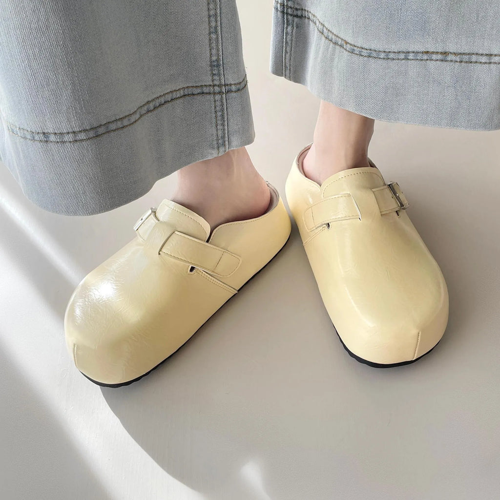 Flat buckle casual sneakers in yellow, creamy-white, silver, and black colours on a white background.