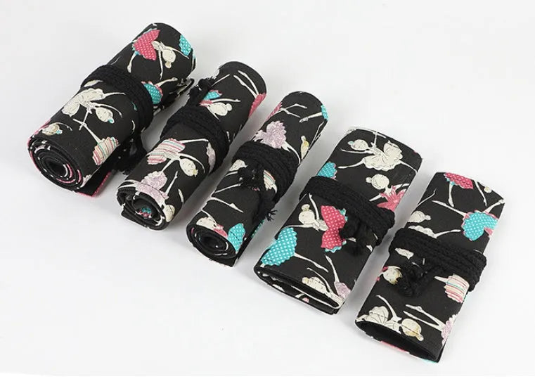Square canvas rolling pencil case with ballet girl print, showing multiple holes for pencils.