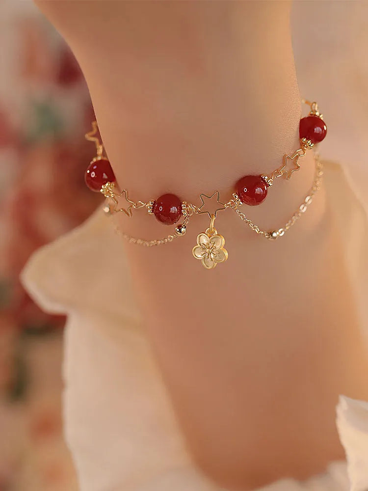 Red agate double layer women's bracelet with carved peach blossom and floral motifs.