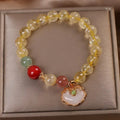 Women's alloy bracelet with a yellow hair crystal jade ruyi pendant charm.