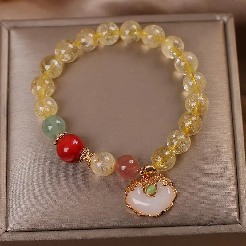 Women's alloy bracelet with a yellow hair crystal jade ruyi pendant charm.