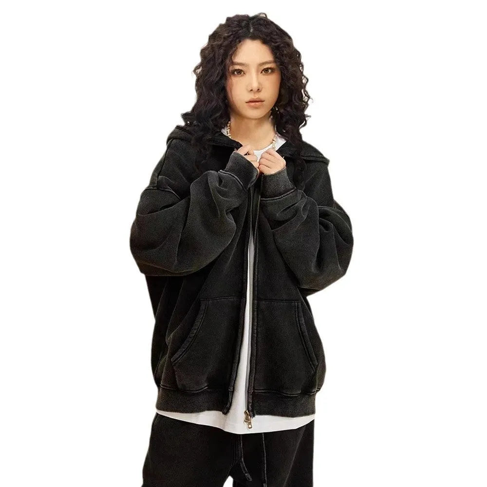 Man wearing a dark green fleece-lined hooded cardigan sweater with a double zipper.