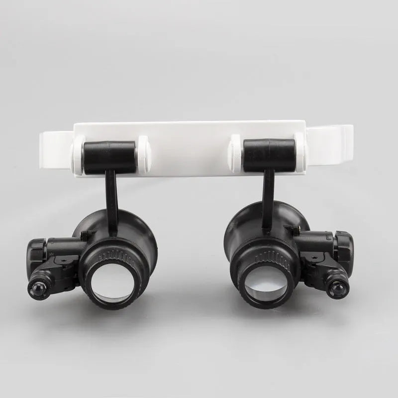 White head mounted magnifying glass with LED light shown in folded and unfolded positions