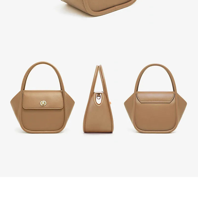 A wing-shaped women's leather tote bag with a buckle latch, shown in blue with a cross-body strap.