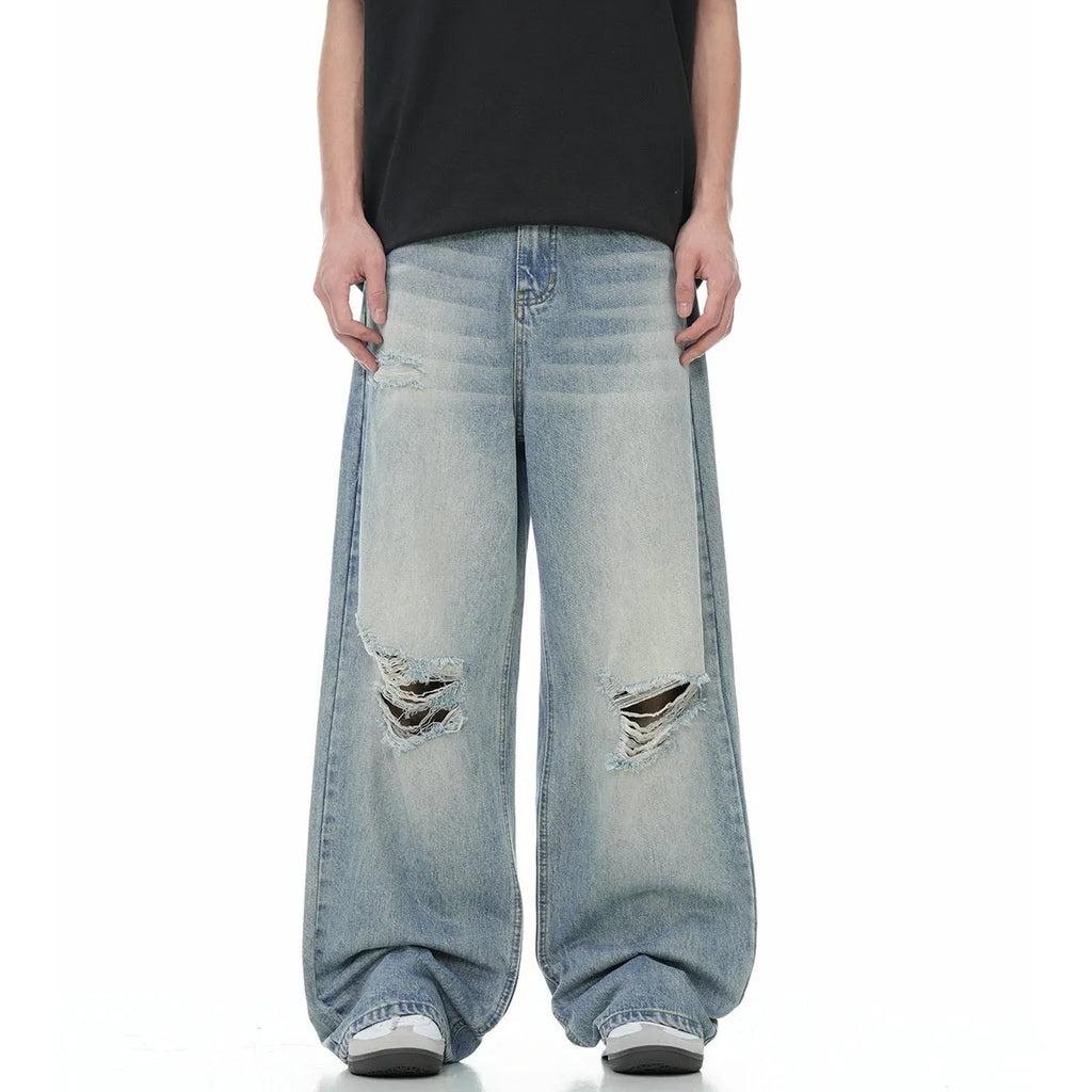 Blue men's straight-leg ripped jeans on a plain background showing cotton blend fabric and zipper fly.