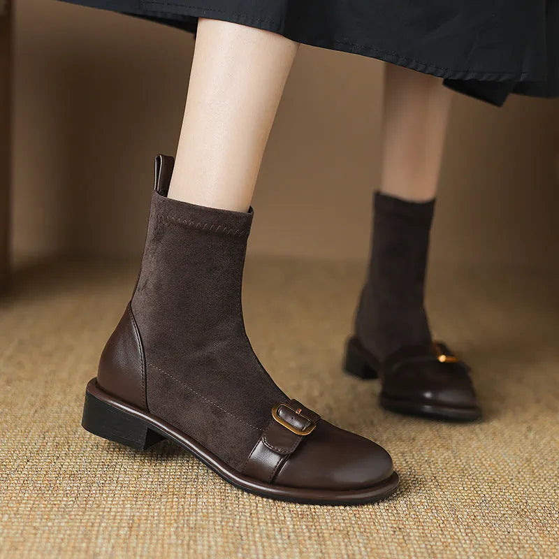 Women's black low heel Martin boots with front lace-up and buckle stitch detail on a round toe.
