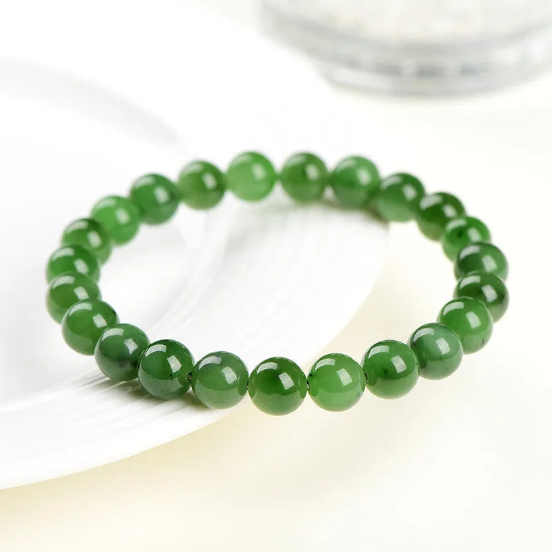 Natural Hetian jade beaded bracelet in various bead sizes on a plain background.