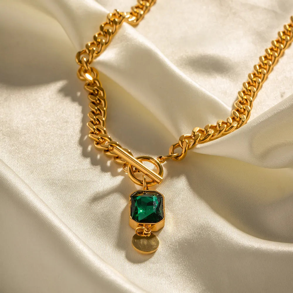 Gold electroplated titanium steel necklace with emerald zircon geometric pendant on Cuban link chain