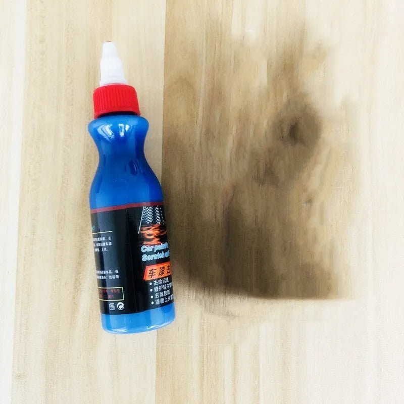 Blue car scratch repair kit with bottle of repair agent and application tool for automotive paint touch-ups