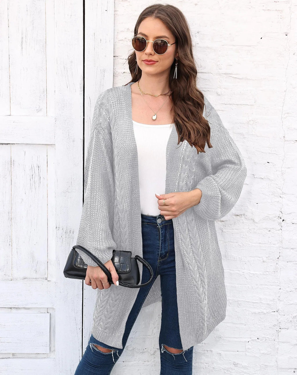 Women's loose acrylic sweater coat in army green, shown on a hanger.