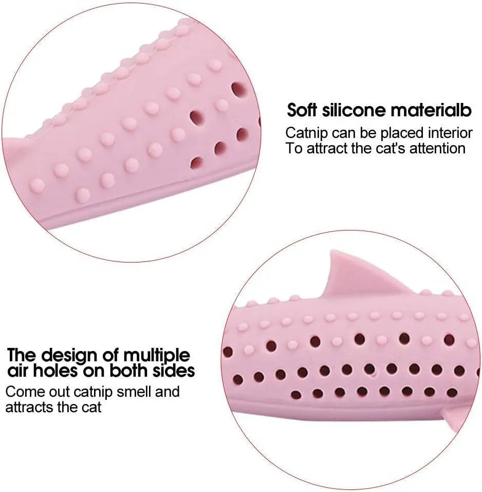 Green silicone fish-shaped cat chew toy with dolphin details and visible side holes.
