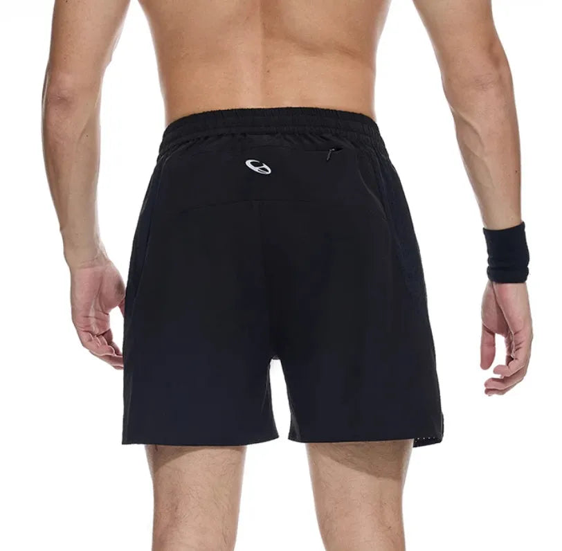 Men's black four-point running shorts with laser stitching on a flat surface, showing stretch fabric.