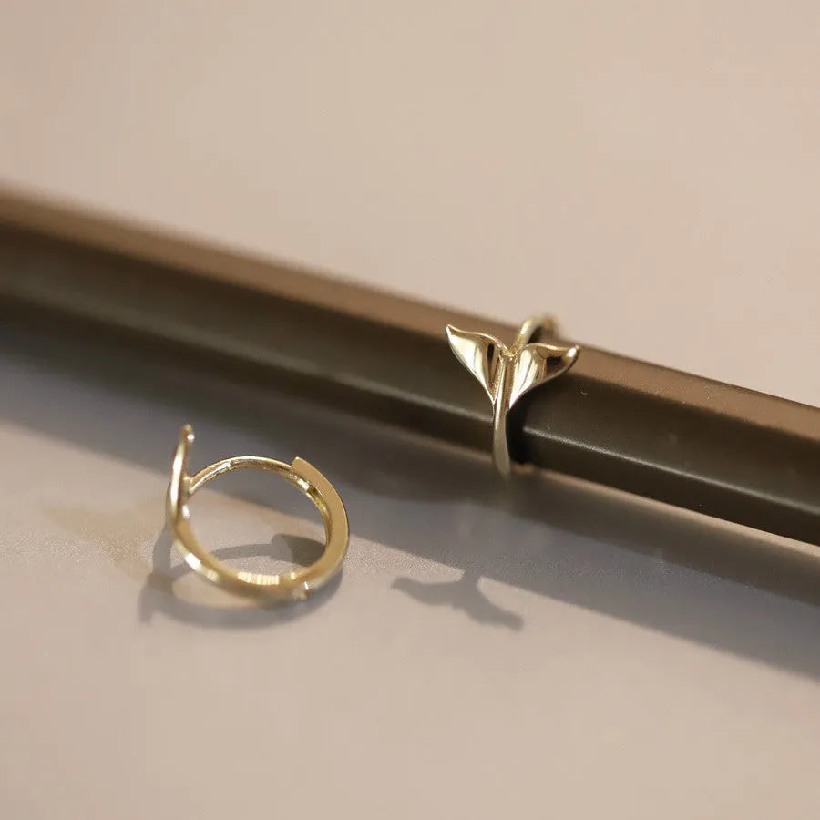 Gold plated sterling silver fish tail earrings for women, showing simple design and smooth finish.