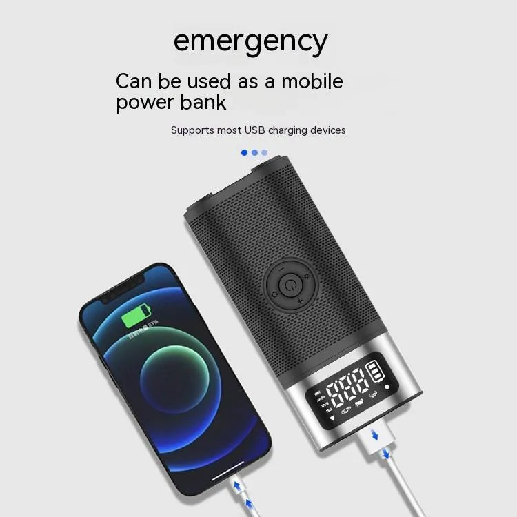 Black portable wireless air pump with digital display, LED light, and attached inflation tube on a textured surface.