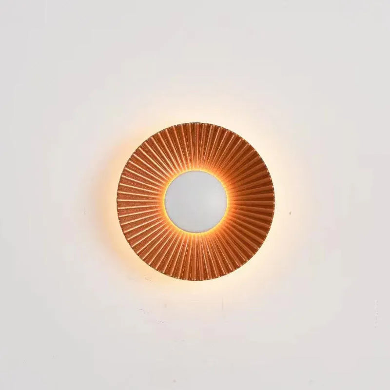 Round aluminium wall lamp with white and gold colour options mounted on wall