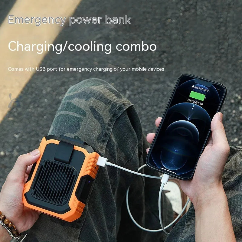 Green wrist hanging portable fan with LED light and USB charging port, showing its compact design.