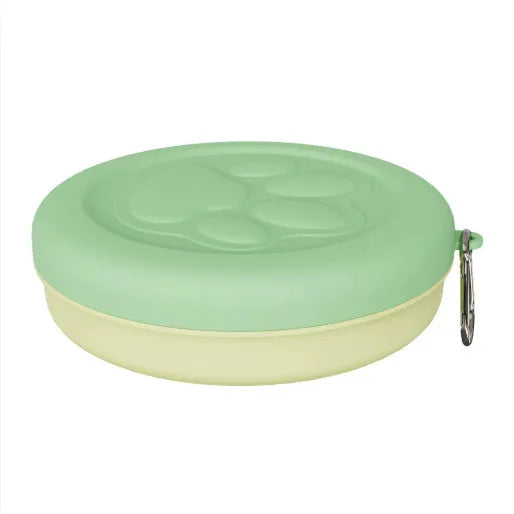 Collapsible portable dog bowl in light green with a separate snack box compartment, shown in its open state.