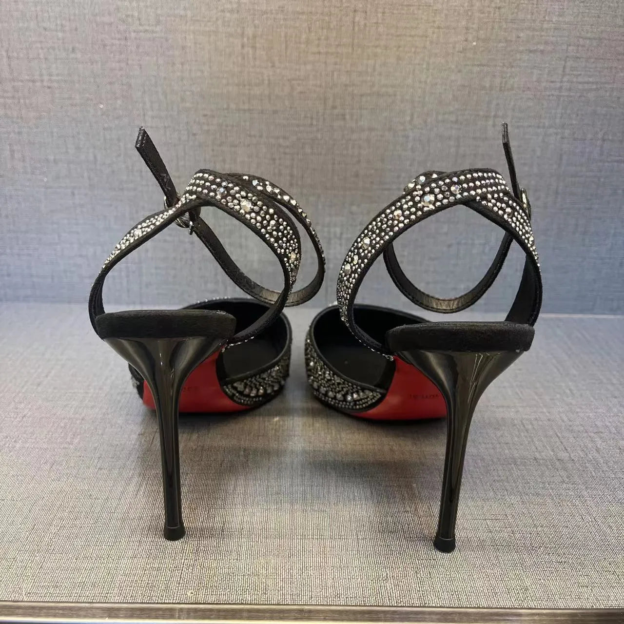Women's black hollow high heels with red sole and pointed toe stiletto design