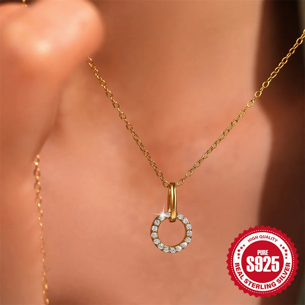 Gold-coloured sterling silver clavicle chain with interlocking geometric design and zircon stones